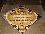 Plaque marking the spot where Jacques Cartier knelt to receive the blessing of the bishop of Saint Malo before his voyage to Canada in 1535.  The plaque records that Honoré Mercier the Prime Minister of Quebec visited the cathedral in 1891.