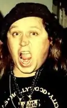 Kinison with his mouth agape