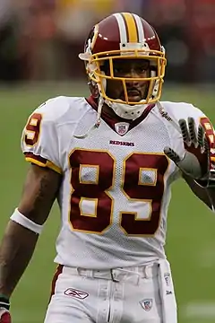 A dark-skinned man wearing American football attire