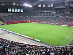 Football field installed inside the stadium, during a football match.