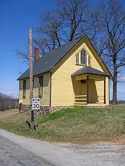 A frame school building on a stone foundation at Trout School Road and Rambo Hill Road in Felton