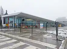 Photo of a glass panelled subway station and bus terminal behind protective fencing