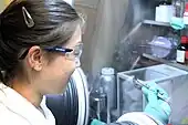 A scientist in UCL Chemical Engineering uses a glovebox to manipulate a sample