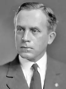 Upper-body portrait of a man in a suit.