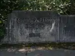 The bridge name ("Schmitz Park Bridge") and year ("1936") completed engraved on in concrete