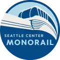 The logo of the Seattle Center Monorail system, which consists of a circular badge with a stylized monorail train