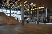 Interior of the lobby, with blue glass bridge against the upper windows