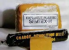 Two blocks of Semtex-1H (note the characteristic orange color) and an American M112 charge containing C4