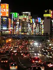 A nighttime view of a Tokyo highway filled with cars.