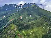 The mountains of Shiretoko Peninsula from Mount Rausu (July 2007). In the foreground is Mitsumine, in the middle field is Mount Sashirui, and in the background is Mount Iō