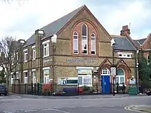 A yellow brick building of very similar appearance to the church