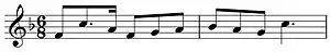 Musical notation showing a theme in F and in 6/8 time on a treble clef.