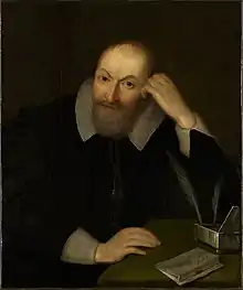 Chiaroscuro painting of Henry Wotton, bearded, dressed in black with turned-back white cuffs and collar, seated at a desk with a silver writing box and quill pens