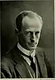 Man wearing a tie, waistcoat and jacket.