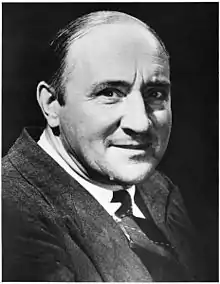 Head and shoulders of smiling man in a suit and tie