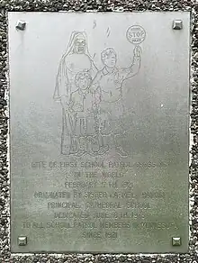 Image showing metal plaque depicting a nun with two children and words commemorating the first school patrol crossing in Saint Paul Minnesota on February 17, 1921