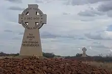 Photograph of two memorial crosses on stone mounds