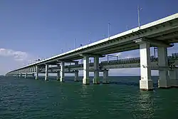 Sky Gate Bridge R at Kansai International Airport, Osaka, Japan, is the longest double-decked truss bridge in the world. It carries three lanes of automobile traffic on top and two of rail below over nine truss spans.