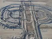 Skylink guideway above Terminal E (left) and Express South Parking Lot/future site of Terminal F (right)