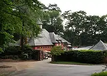 A two-story brick building and complex housing golf carts