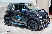 Front three quarter view of black Smart EQ Fortwo, at Geneva International Motor Show 2018.