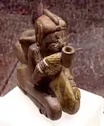 Effigy pipe of a man smoking a pipe, Missouri flint clay