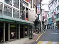 A view of "Aragon Alley" where most of the establishments are bars, note the open door on the second floor.