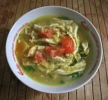 Soto ayam, chicken soto in soup with turmeric and spices