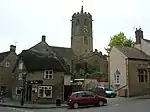 Street scene showing houses with octagonal church tower behind