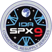 NASA's SpX-9 mission patch graphic simulates the view from inside IDA-2, displaying the three petals of the docking adapter.