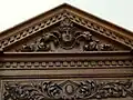 Carved pediment in music room