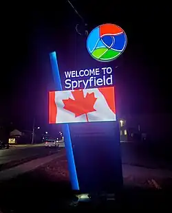 LED sign at night flashing an image of the Canadian flag