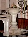 The marble baptism font inscribed in German