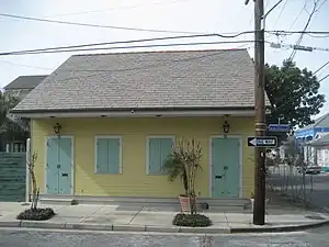 Weatherboard Creole Cottage with two sets of French doors and two double hung windows