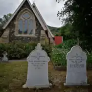 an image of St Cuthbert's church, with gravestones in the foreground