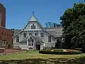 The modern cathedral complex includes Mountfort's earlier wooden cathedral of 1886. The terminating gables served as an inspiration to the façade of the cathedral nave