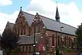 St Thomas's Church, Islington, London, 1888–89 by Ewan Christian, view of west front and south aisle showing Early English style lancets and narthex below the west windows