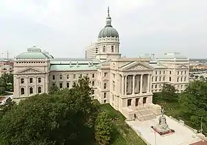 A large white building with two long sweeping wings