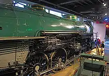 A close-up of a large steam locomotive's running gear