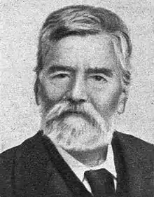 Black-and-white photograph of an elderly, bearded man.