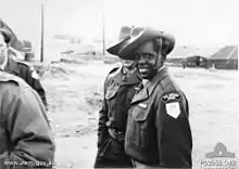 Steve Dodd in a military uniform, including slouch hat, smiling at camera.