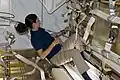 The NASA astronaut Nicole Stott working inside HTV-1, 8 days later, with some supplies already removed.