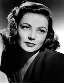 A black and white studio portrait of Gene Tierney