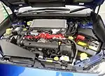 Open engine compartment of a Subaru WRX STI for the Japanese market, showing the horizontally-opposed "boxer" engine coded "EJ207"