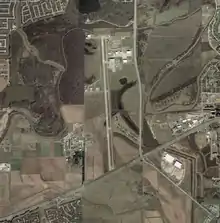 Aerial photograph of the airport and the Central Unit prison property, which is on both sides of the runway, on January 27, 2002 - U.S. Geological Survey