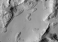 Sulci Gordii Terraced Hills, as seen by HiRISE. Many dark slope streaks are visible.