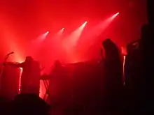 Sunn O))) onstage, bathed in red light