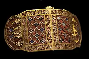 Shoulder-clasps from Sutton Hoo; early 7th century; gold, glass & garnet; length: 12.7 centimetres (5.0 in); British Museum (London)