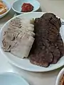 Suyuk (boiled pork slices) and pyeonyuk (pressed boiled beef slices)