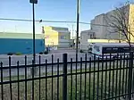 back of a bus behind a wrought-iron fence